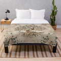 Yggdrasil, the mystic tree of life, depicted on a cozy plush blanket with birds, butterflies, and golden leaves.