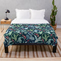 Dark blue and green plush blanket with a fantasy fire-breathing dragon design