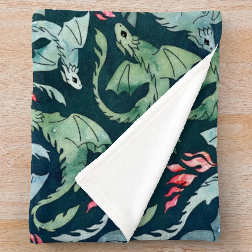 Dark blue and green plush blanket with a fantasy fire-breathing dragon design