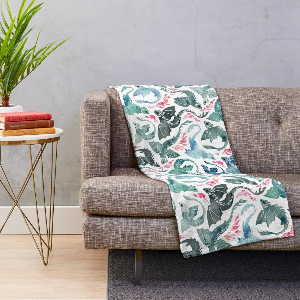 Plush dragon fire-themed blanket in blue, green, and gray colors