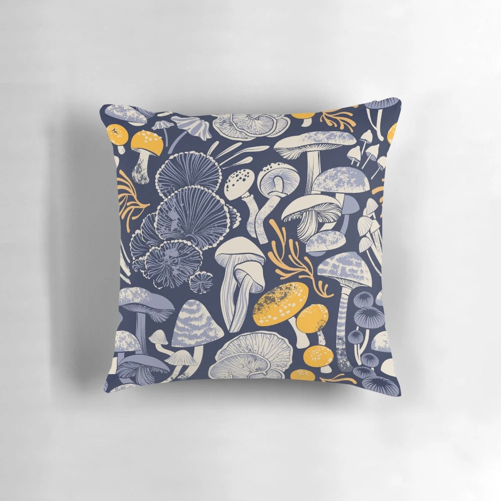 Pillow with a midnight blue background featuring ivory, pale blue, and yellow wild mushrooms in a botanical, vintage-inspired pattern.