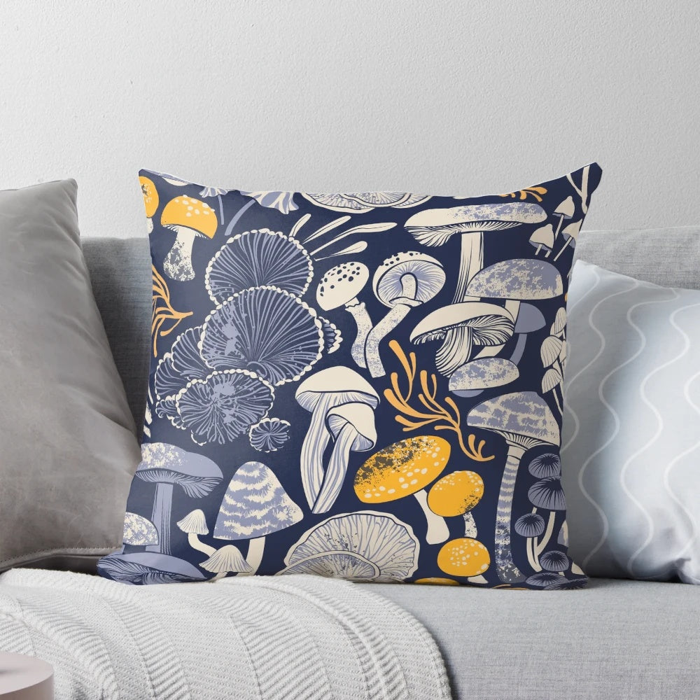 Pillow with a midnight blue background featuring ivory, pale blue, and yellow wild mushrooms in a botanical, vintage-inspired pattern.
