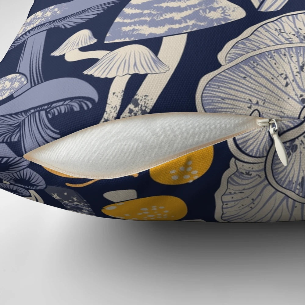 Pillow with a midnight blue background featuring ivory, pale blue, and yellow wild mushrooms in a botanical, vintage-inspired pattern.