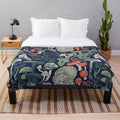 Mystical fungi patterned plush blanket with midnight blue, sage green, forest green, and orange wild mushrooms