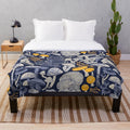 Mystical fungi plush blanket featuring ivory, pale blue, and yellow wild mushrooms on a midnight blue background