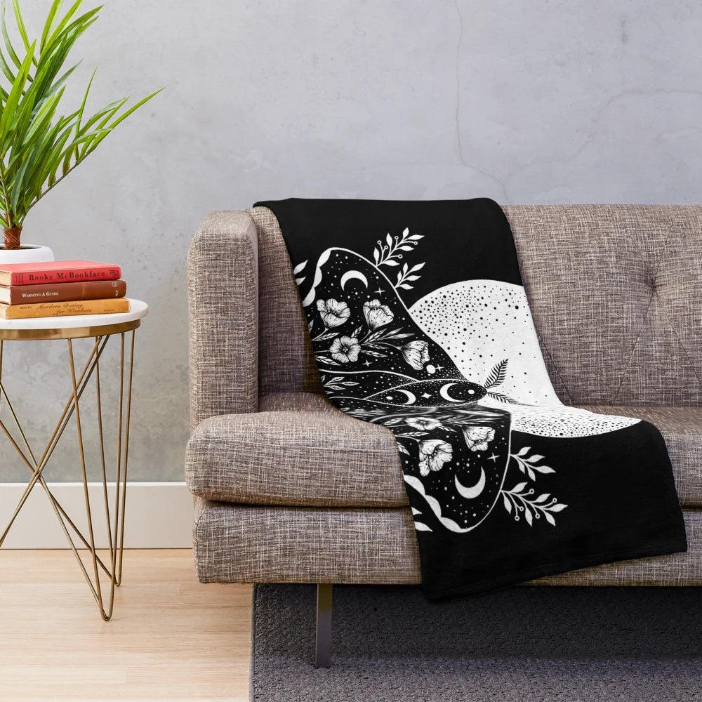 Plush blanket with a mystical moon and moth design for bohemian-style home decor