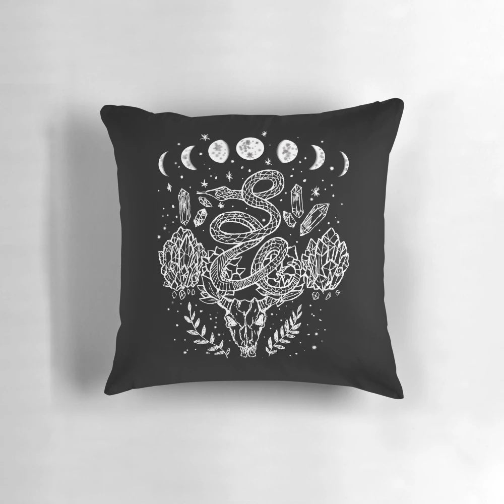 A decorative throw pillow featuring a moon phases, snakes, and crystals witchy design.