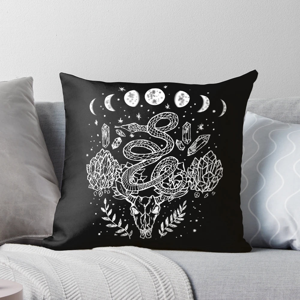 A decorative throw pillow featuring a moon phases, snakes, and crystals witchy design.