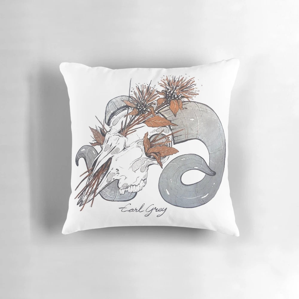 A cozy pillow with a ram skull design, perfect for witchy home decor.