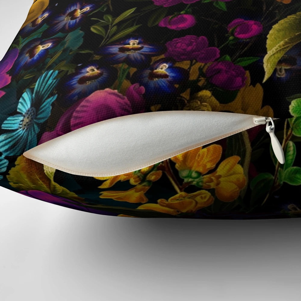 A black and white throw pillow featuring a mystical, botanical night garden pattern.