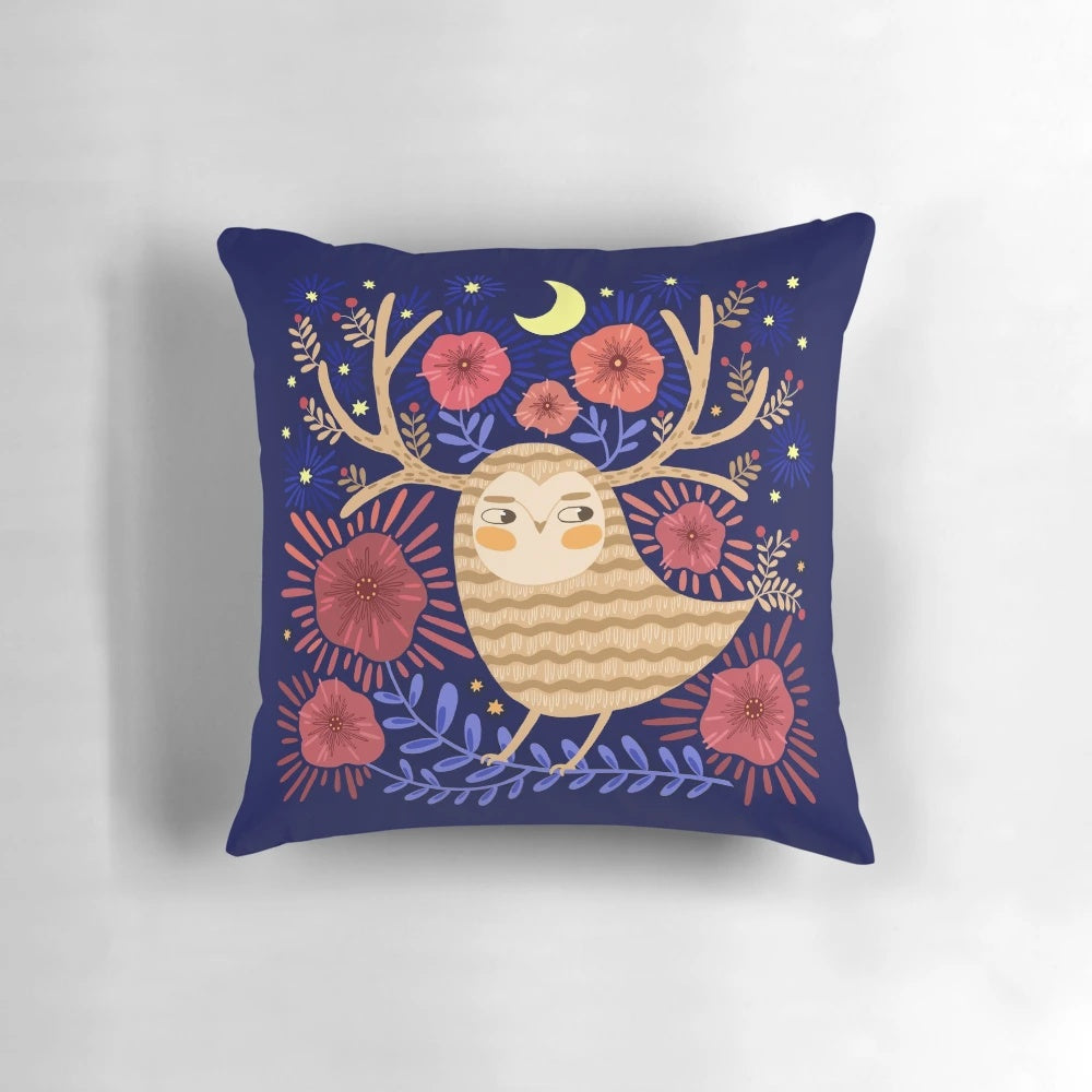 A decorative pillow featuring a mystical owl surrounded by flowers, stars, and a crescent moon against a dark background.