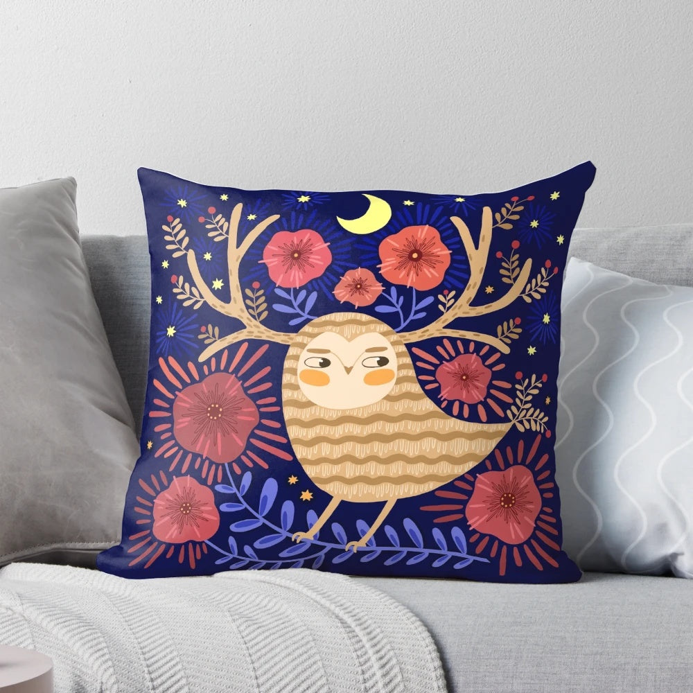 A decorative pillow featuring a mystical owl surrounded by flowers, stars, and a crescent moon against a dark background.