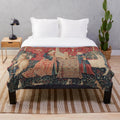 Plush blanket featuring a mythical unicorn in a medieval-style floral tapestry design