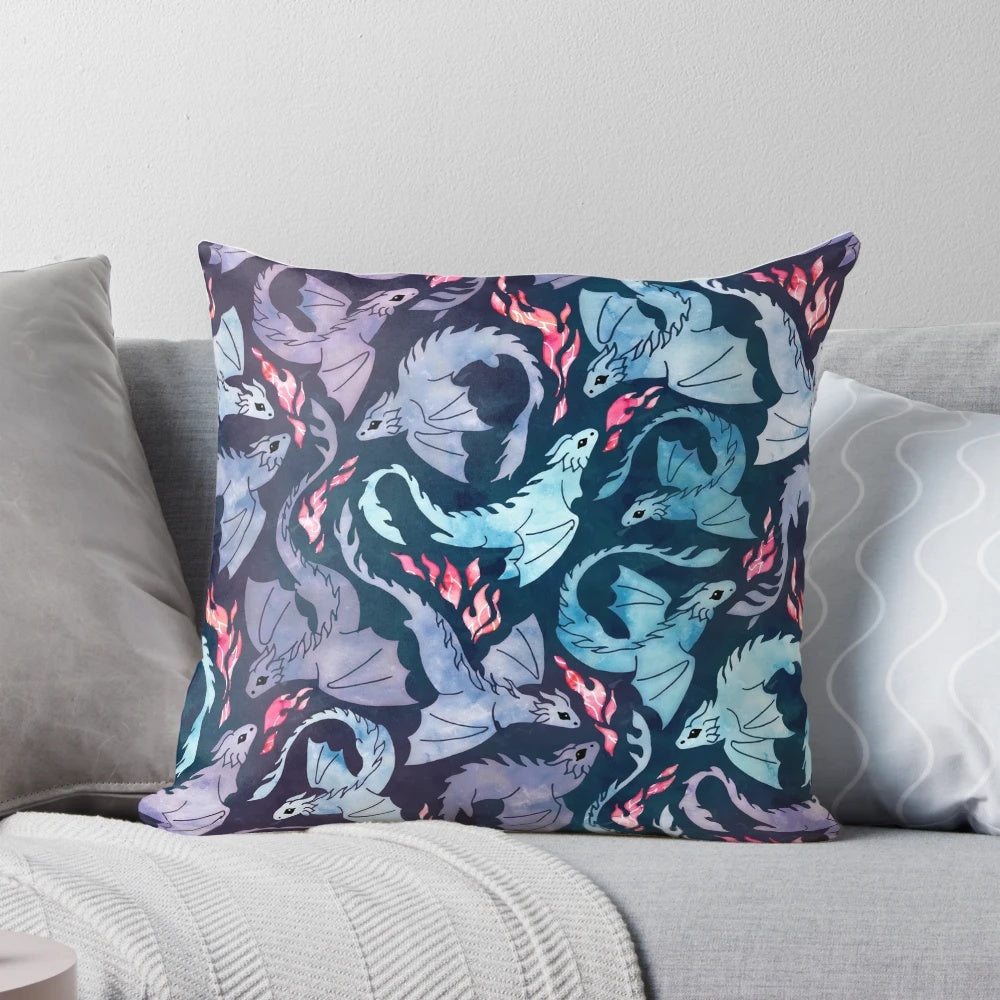 A decorative throw pillow featuring a watercolor-style illustration of a fire-breathing dragon in shades of turquoise and purple.