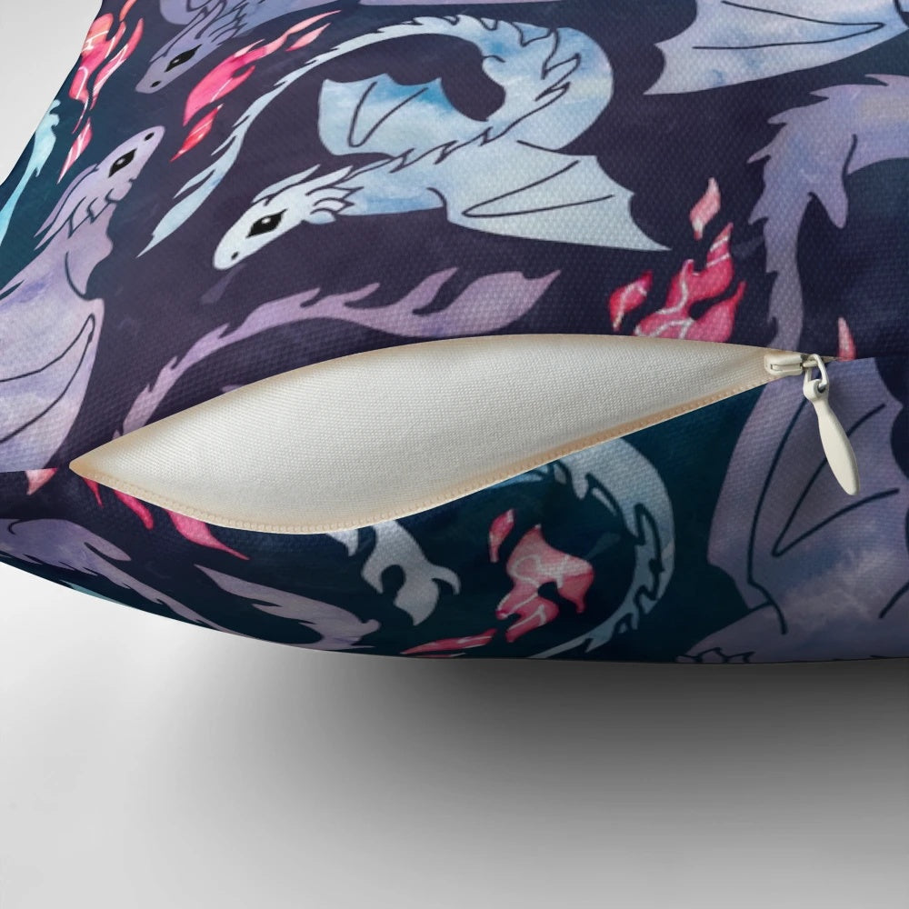 A decorative throw pillow featuring a watercolor-style illustration of a fire-breathing dragon in shades of turquoise and purple.