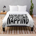 Plush blanket with "Hobbies Include Napping" text