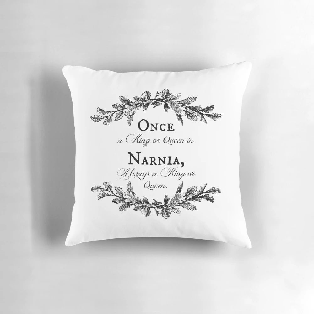 Decorative pillow with a wreath of branches and the quote "Once a King or Queen of Narnia, always a King or Queen