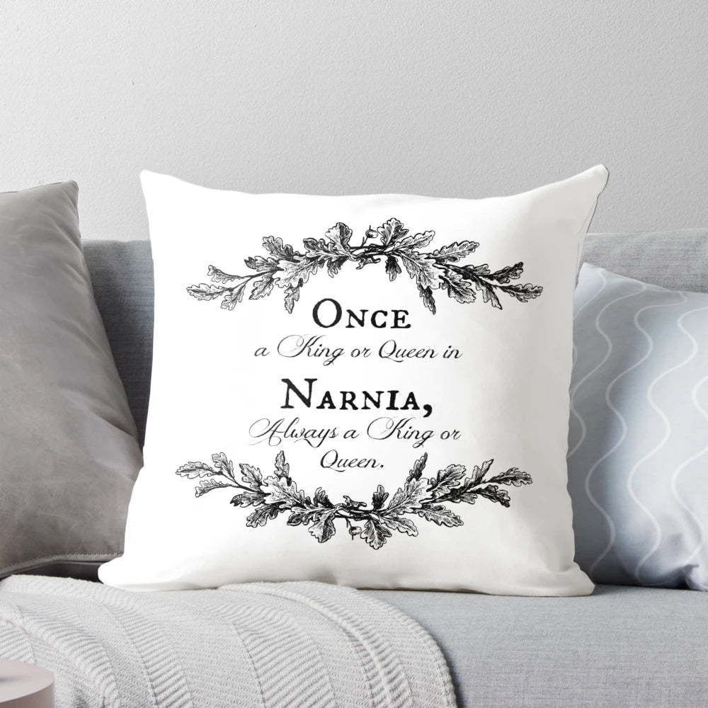 Decorative pillow with a wreath of branches and the quote "Once a King or Queen of Narnia, always a King or Queen