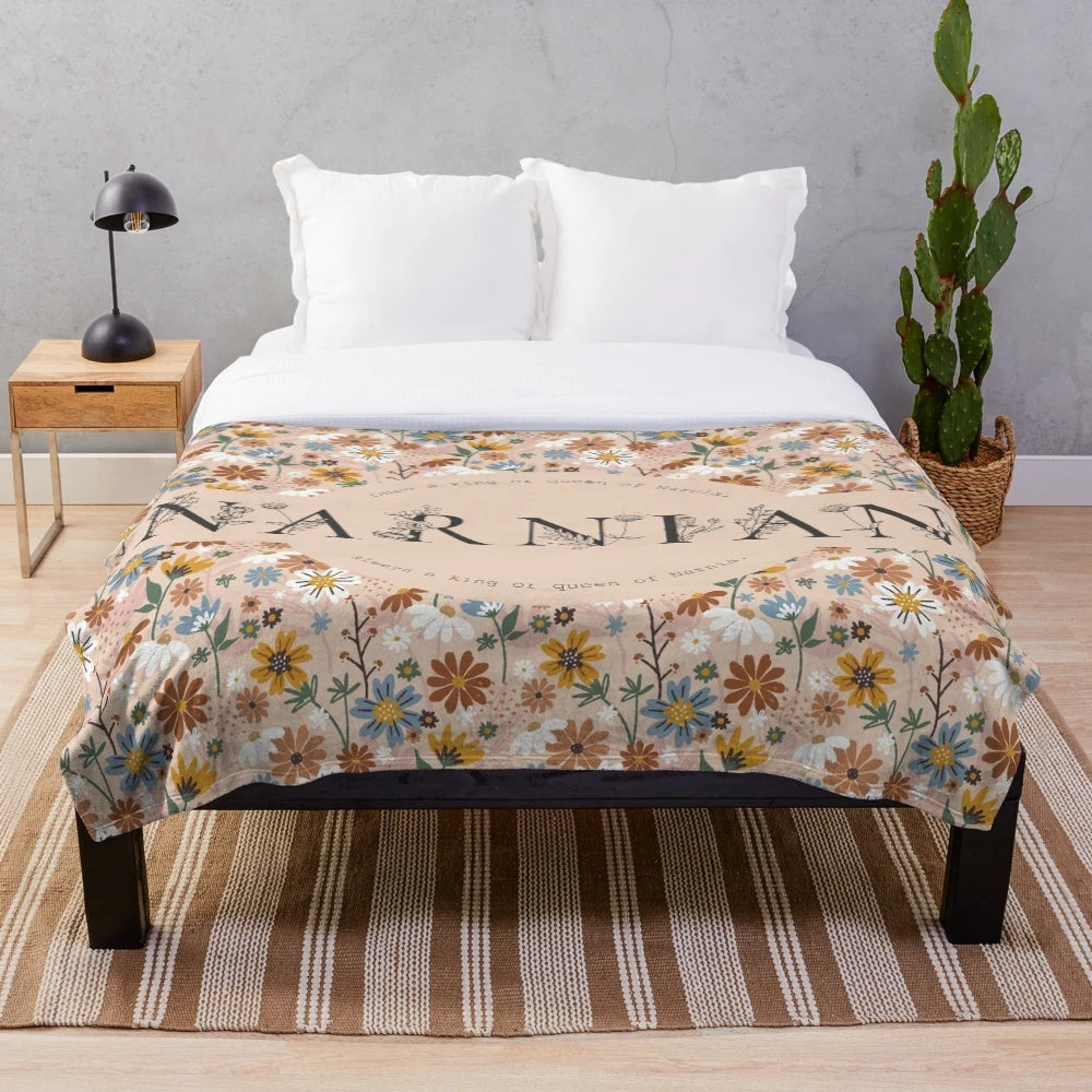 Narnian plush blanket with floral design and quote