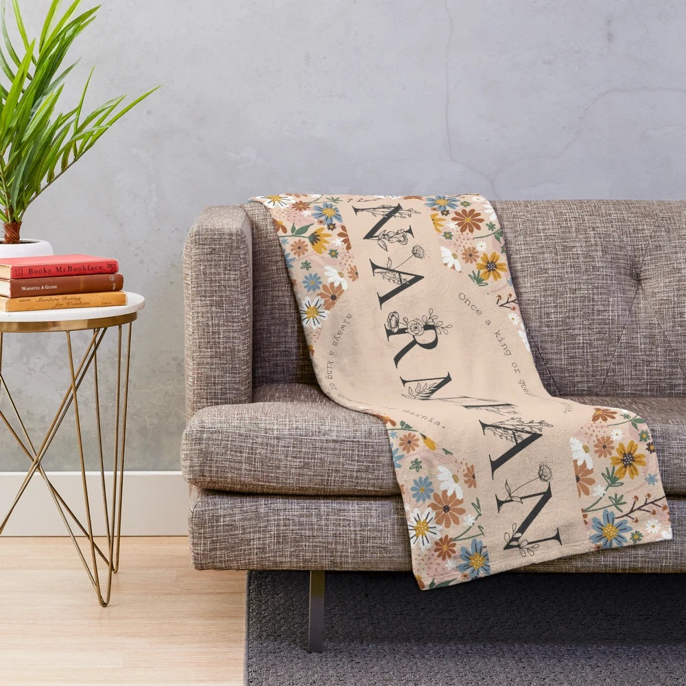 Narnian plush blanket with floral design and quote