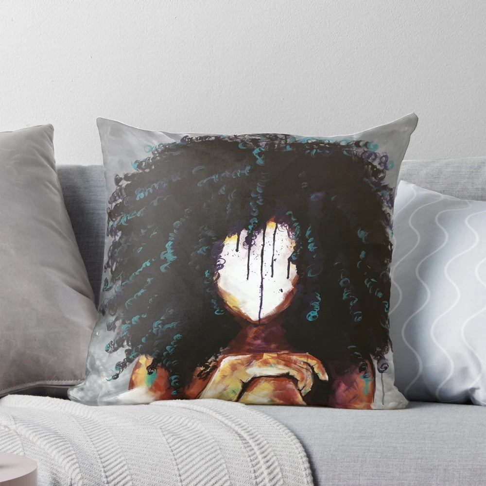 A beautiful, artistic throw pillow featuring a portrait of a regal, black woman with an afro hairstyle.