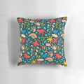 A colorful, nature-themed decorative pillow featuring birds, animals, flowers, rainbows, and clouds on a dark teal background.