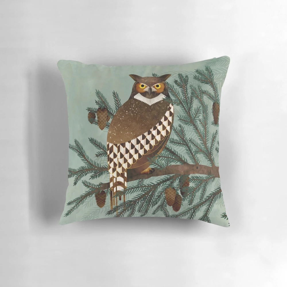 A beautifully crafted pillow featuring a hand-painted great horned owl and pine tree design