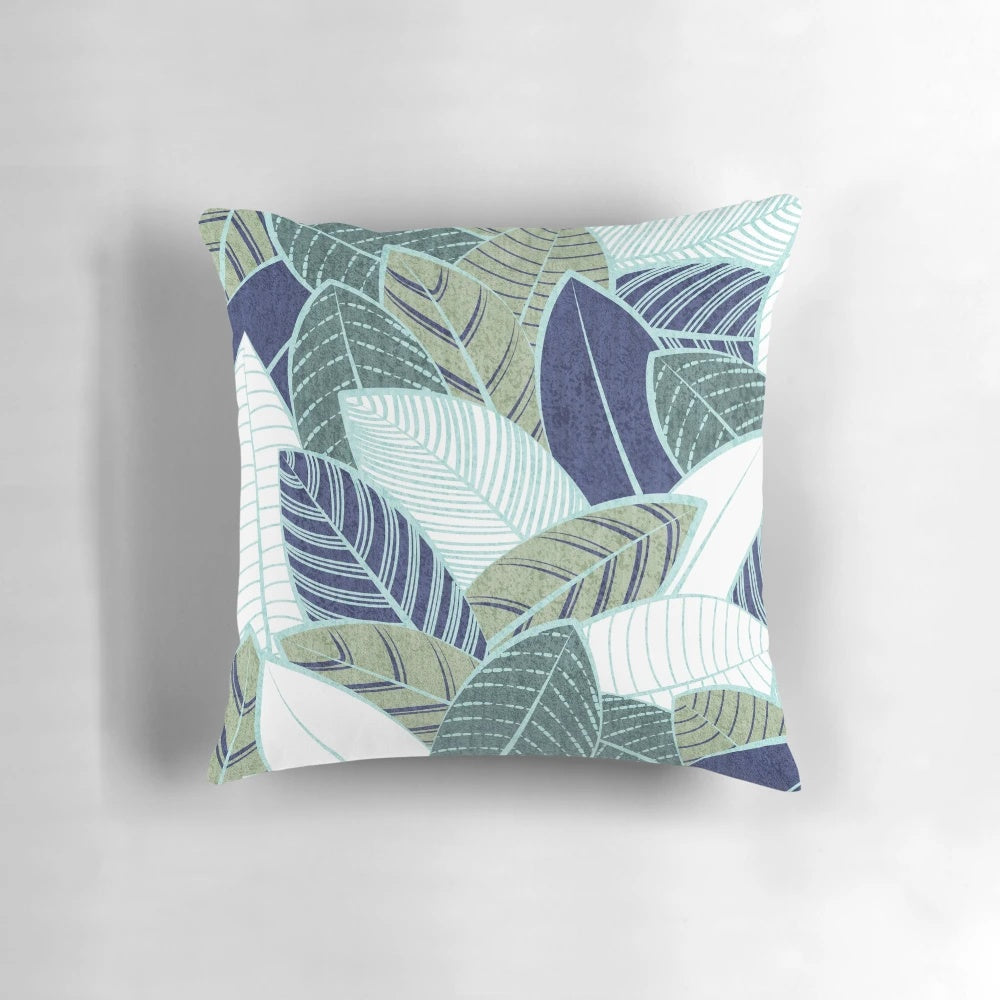 A modern and nature-inspired pillow featuring navy blue, sage green leaves, and mint lines in a beautiful botanical design.