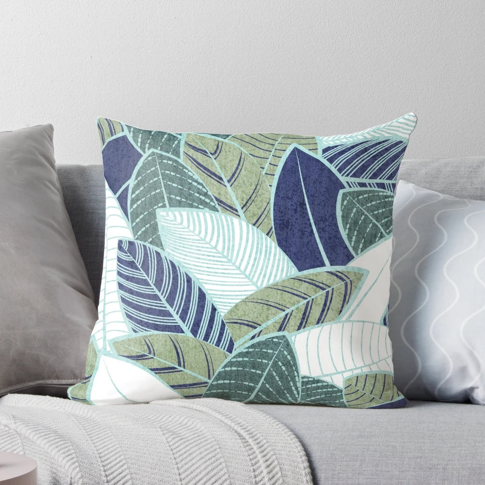 A modern and nature-inspired pillow featuring navy blue, sage green leaves, and mint lines in a beautiful botanical design.