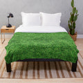 Soft and cozy plush blanket with a nature-inspired grass-like texture