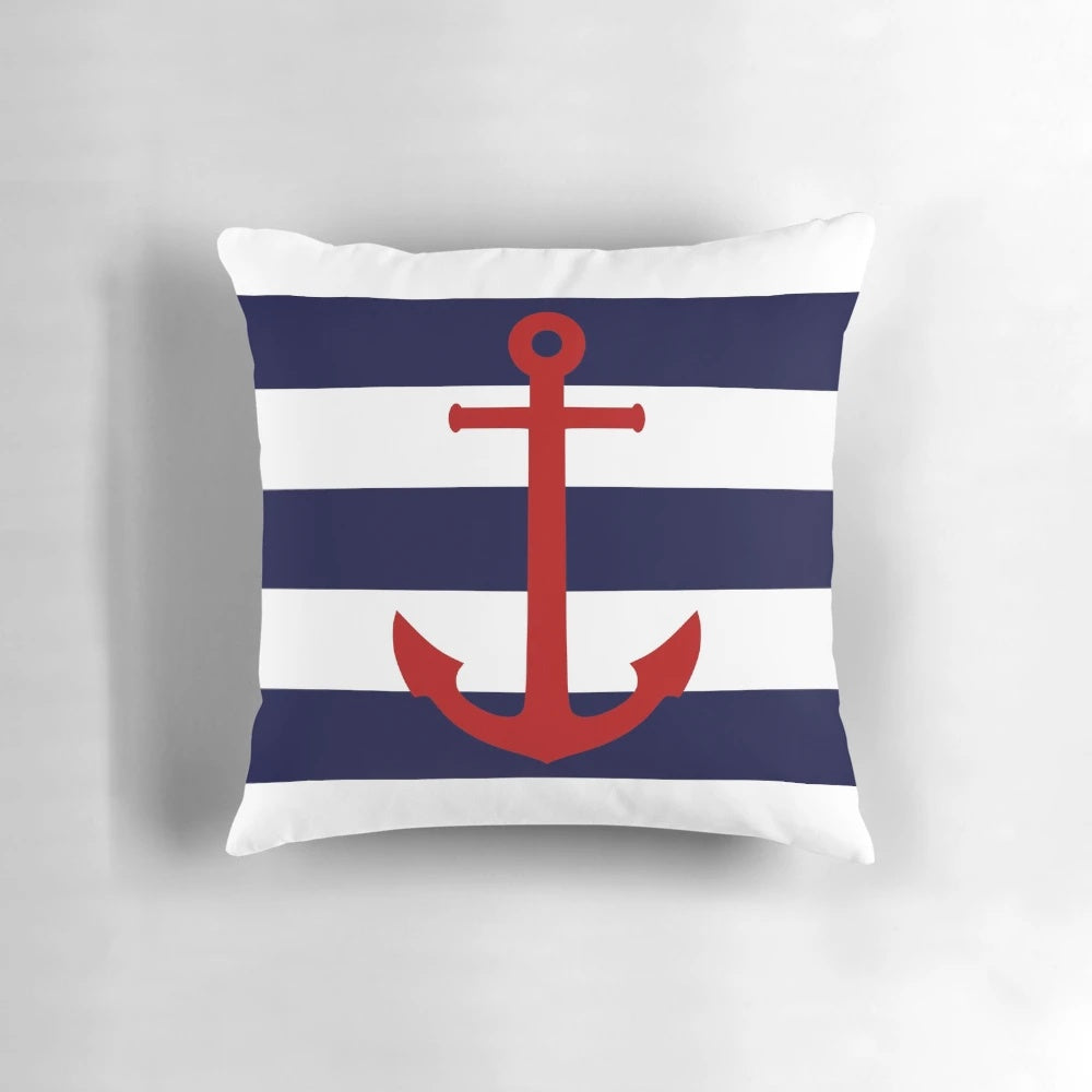 Nautical-inspired pillow with a red anchor design on navy blue and white striped background
