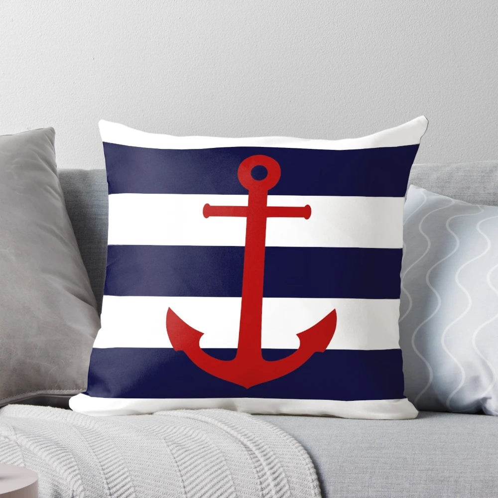 Nautical-inspired pillow with a red anchor design on navy blue and white striped background