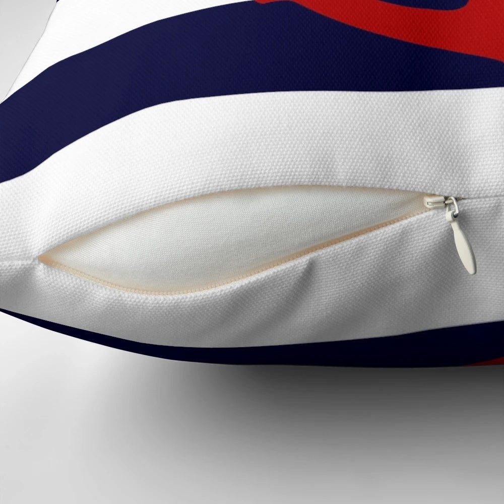 Nautical-inspired pillow with a red anchor design on navy blue and white striped background