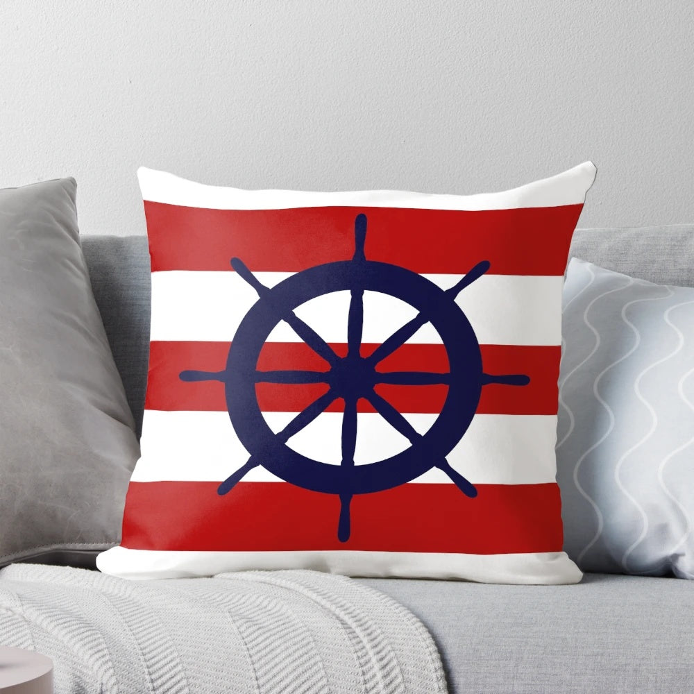 A nautical-themed accent pillow featuring a navy blue and red striped design with a ship's steering wheel in the center.
