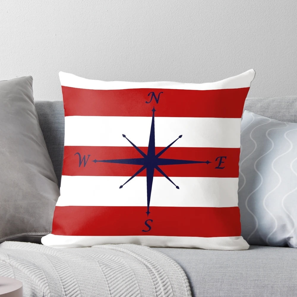 Nautical compass design on a navy blue, red and white striped decorative pillow
