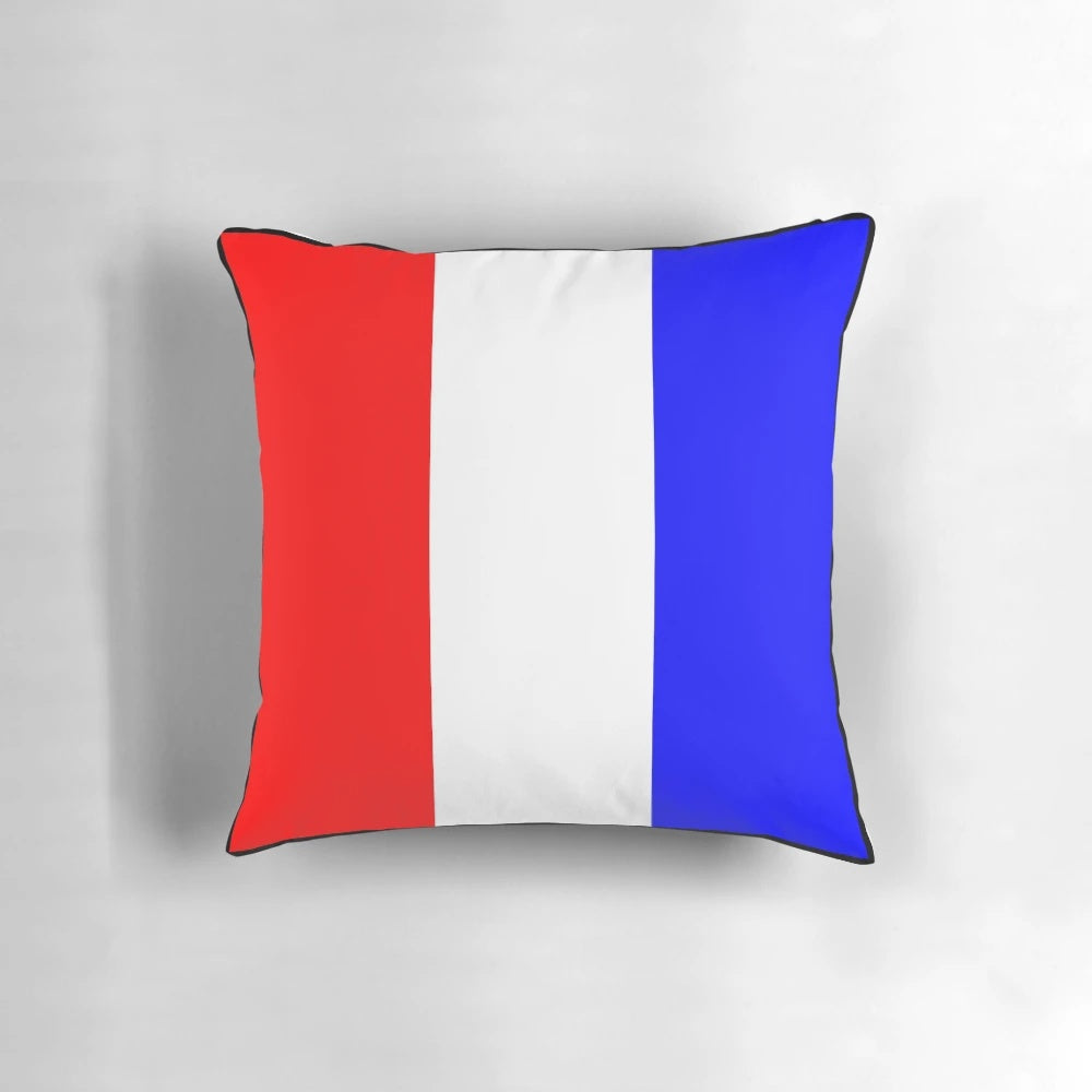 An international maritime signal flags alphabet pillow featuring the letter T, perfect for coastal home decor.