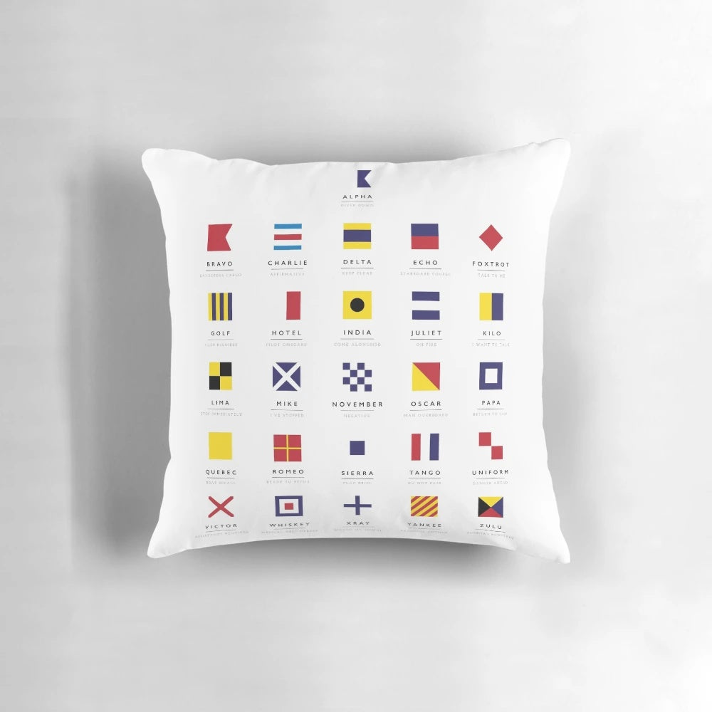 Vibrant nautical flags pillow featuring international maritime signal flags