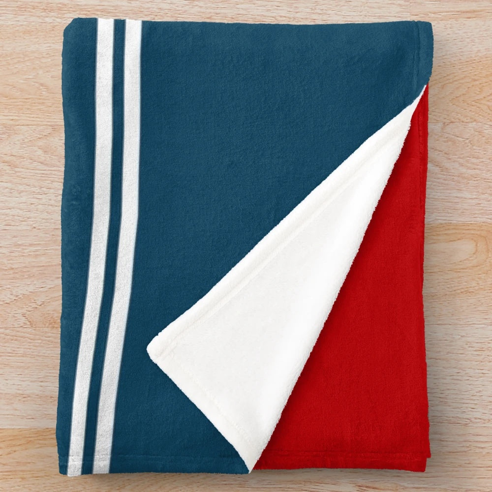 Nautical-themed plush blanket with nautical symbols and striped pattern