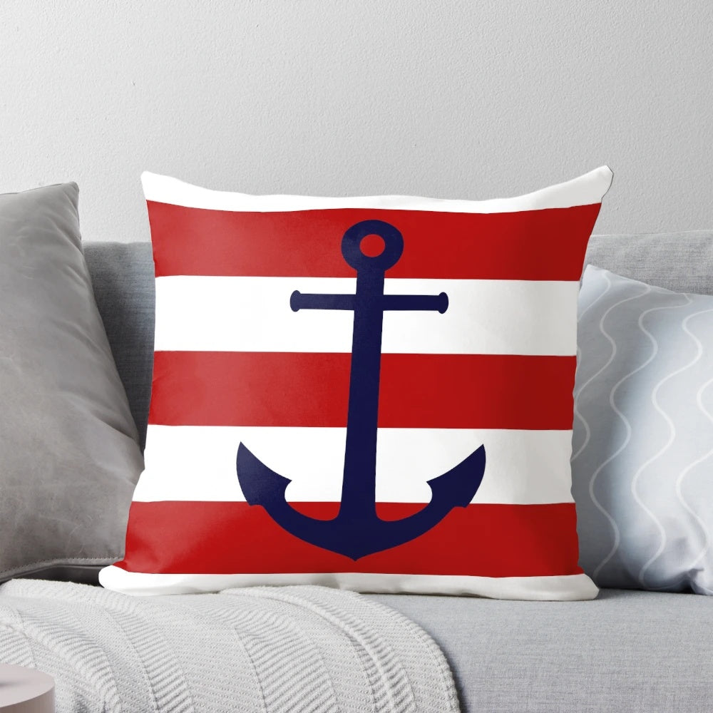 Navy blue anchor print throw pillow with red and white striped design, perfect for nautical or coastal home decor