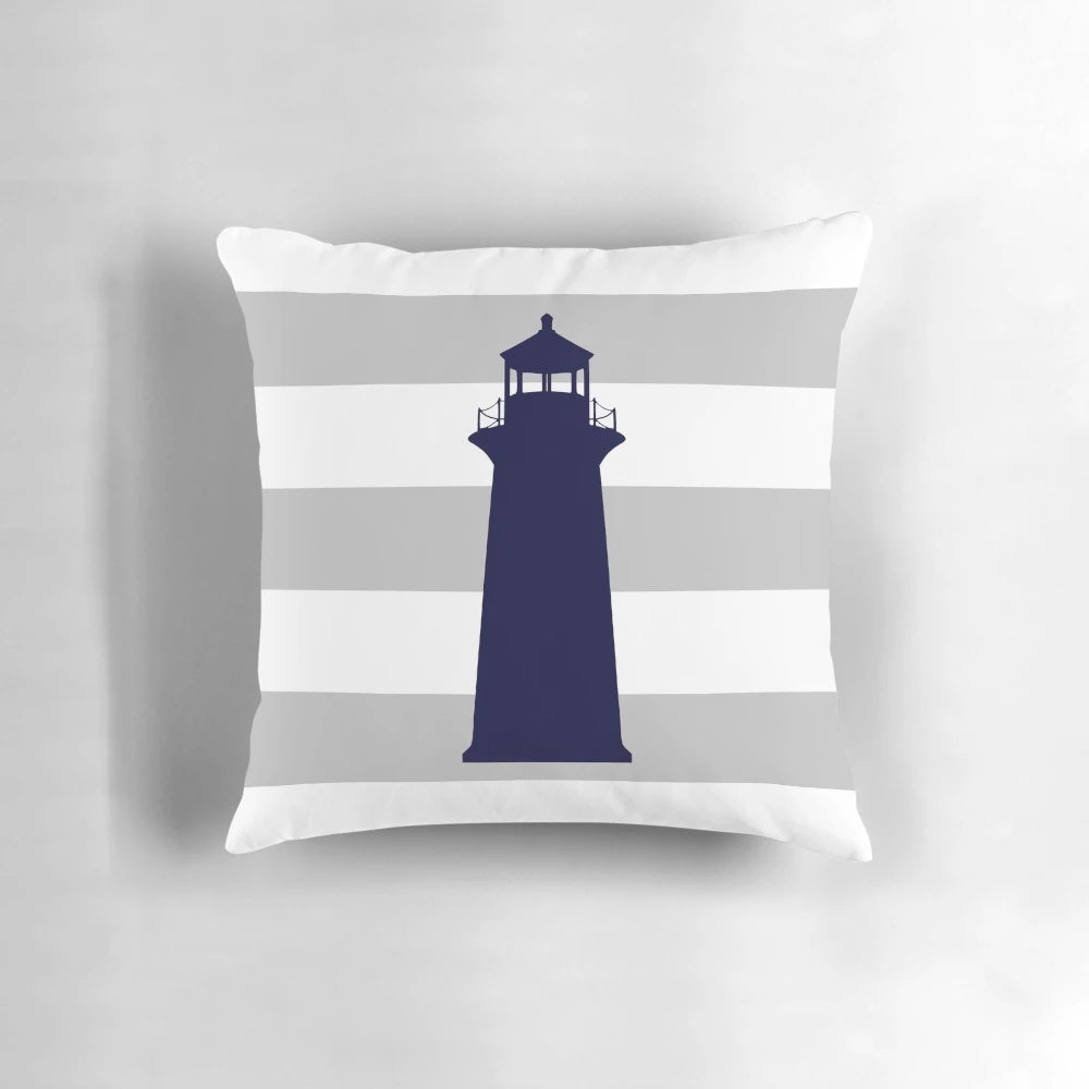 Navy blue lighthouse design on a gray and white striped pillow