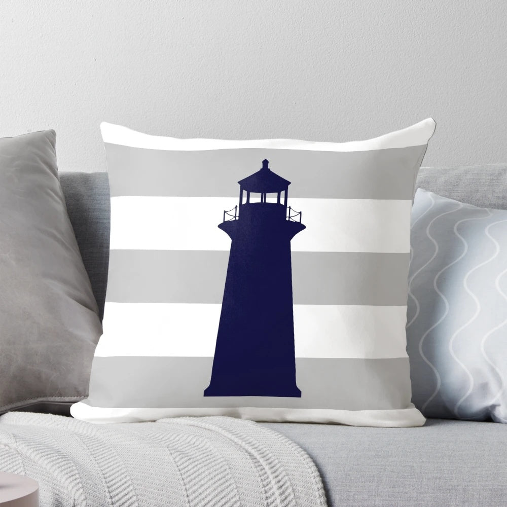 Navy blue lighthouse design on a gray and white striped pillow