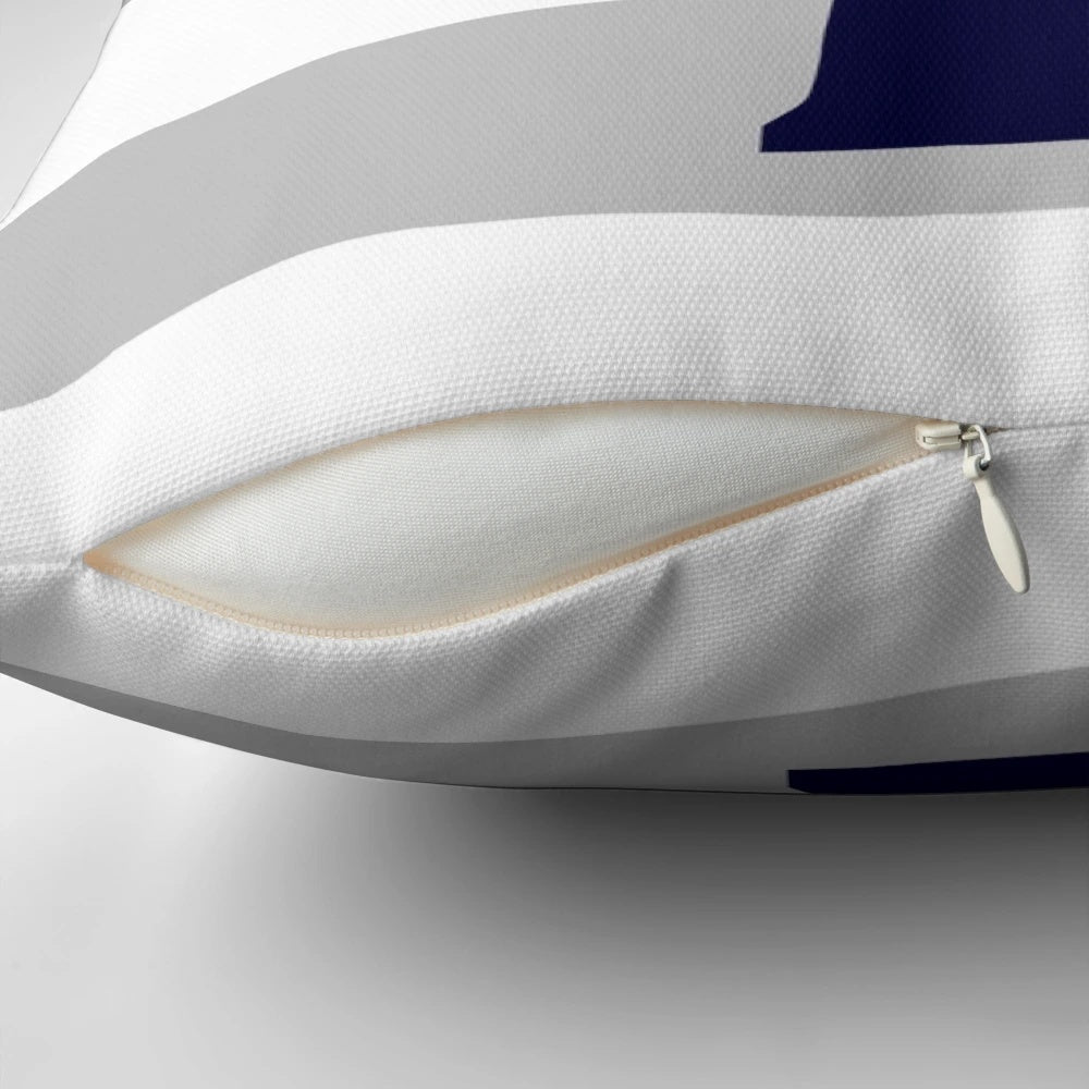 Navy blue lighthouse design on a gray and white striped pillow