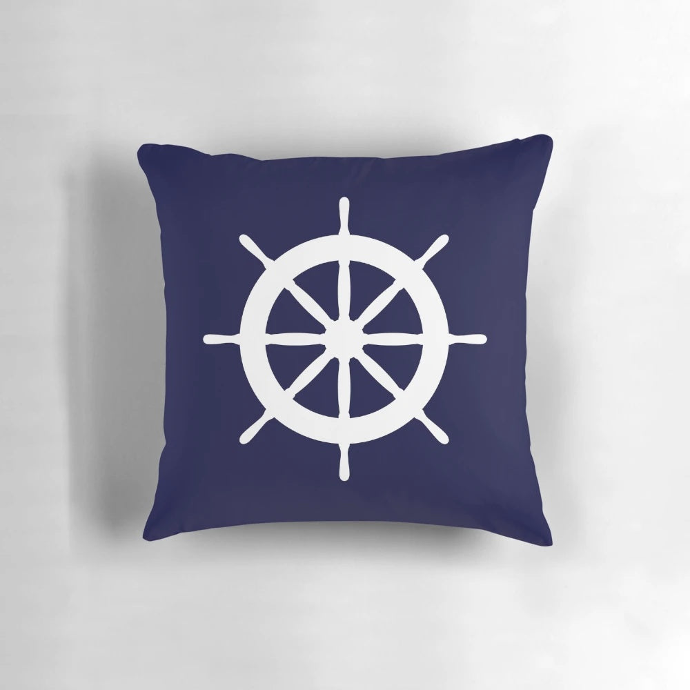 White ship steering wheel against a navy blue background on a plush, high-quality pillow.