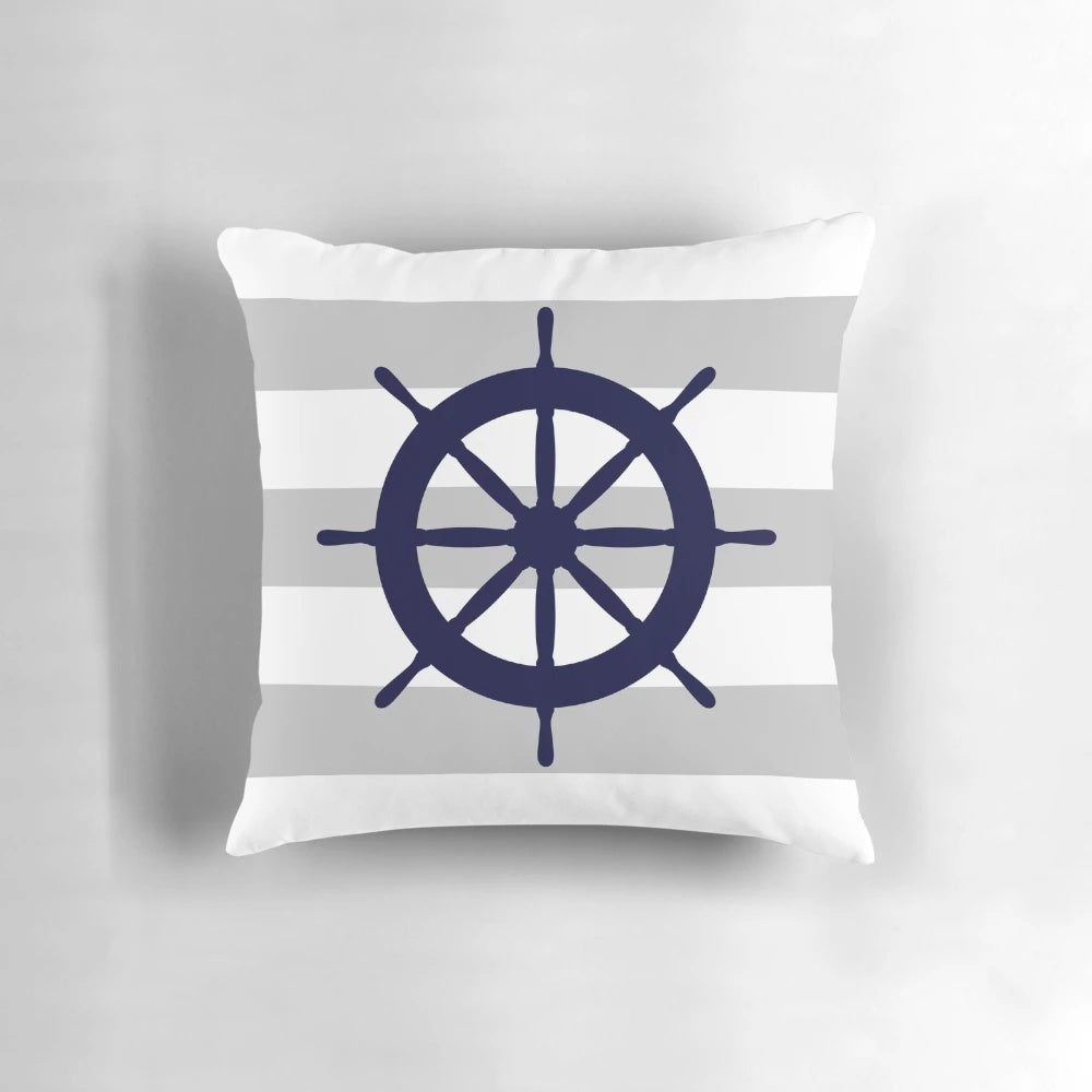 Navy blue and gray striped nautical-themed accent pillow with a steering wheel design