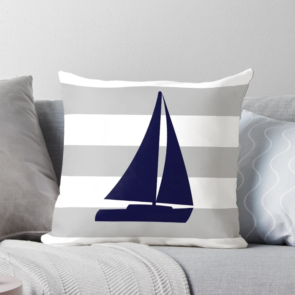 Navy blue and gray striped decorative pillow with a nautical sailboat design