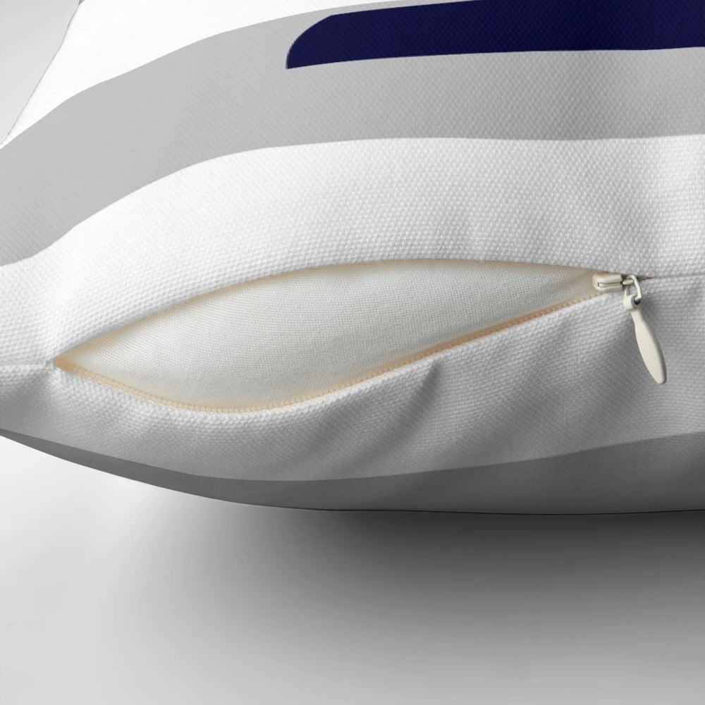 Navy blue and gray striped decorative pillow with a nautical sailboat design