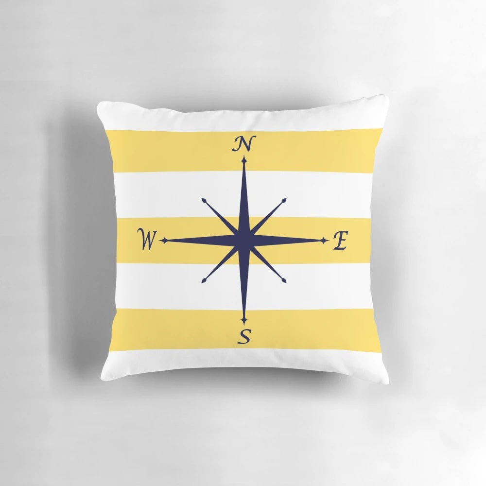 Navy blue and mustard yellow striped pillow with a compass design, perfect for coastal or nautical-themed home decor.