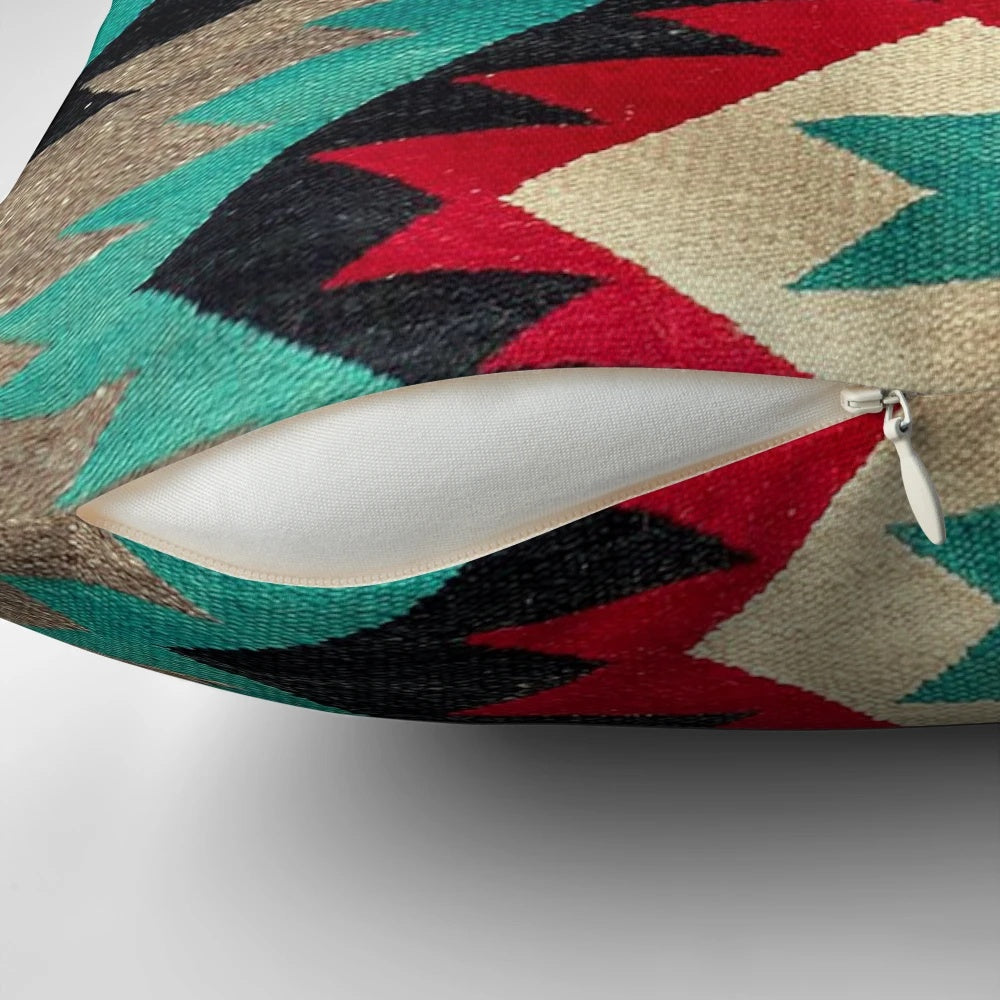 A decorative throw pillow featuring a vibrant Navajo-inspired pattern in shades of turquoise, red, grey, and black.
