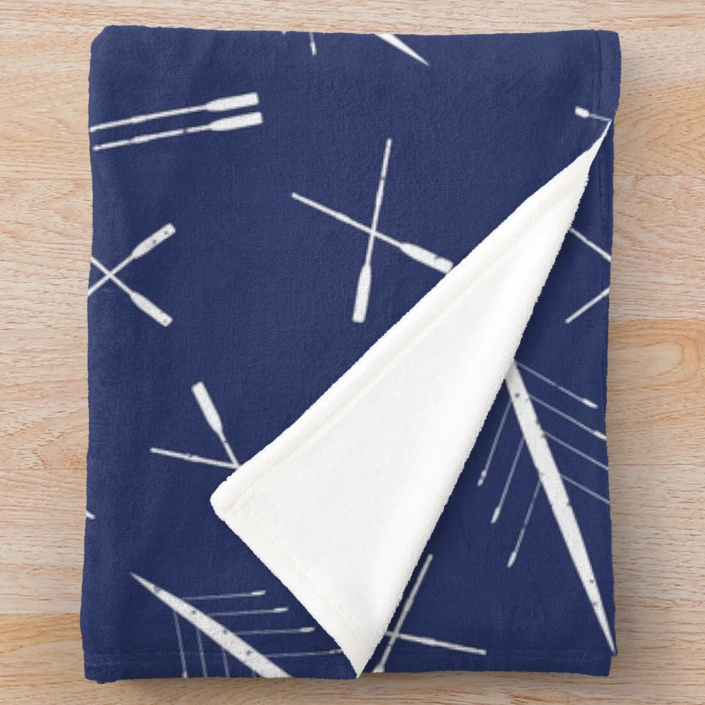 Navy blue and white plush blanket with a scull pattern, perfect for rowing enthusiasts