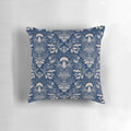 Navy blue and beige damask pattern pillow with illustrations of mushrooms, leaves, and other woodland elements.
